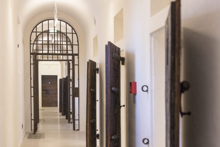 Corridor with the access doors to the former cells of Gallerie delle Prigioni in Treviso, after the restoration